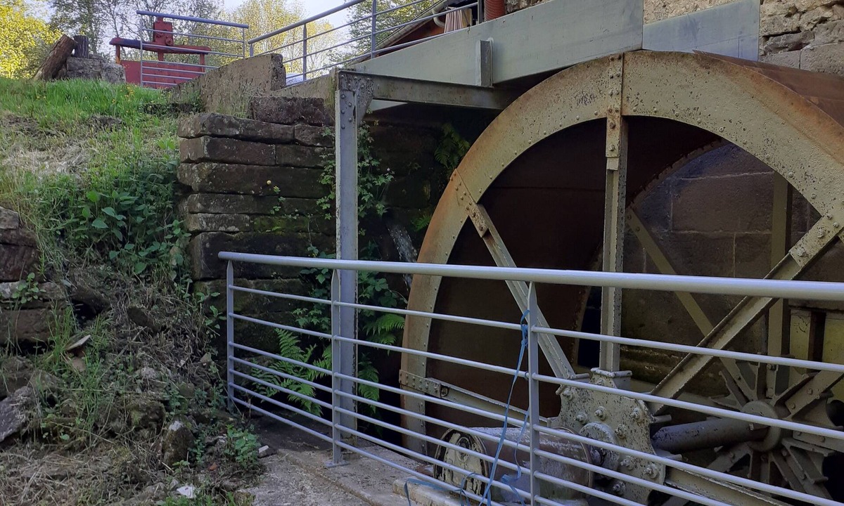 Escles House | Former flour mill with pond on wooded grounds