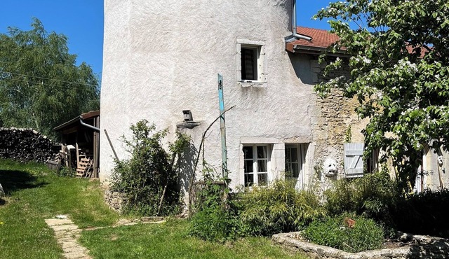 A 16th-century dovecote surrounded by the beautiful grounds of Roncourt Castle